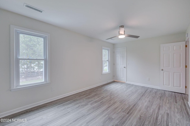 spare room featuring light hardwood / wood-style floors and ceiling fan