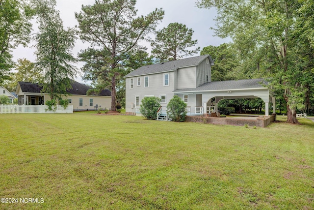 back of house with a lawn