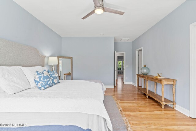 bedroom with ceiling fan and light wood-type flooring