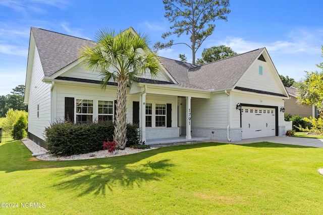 craftsman-style house featuring a front yard and a garage