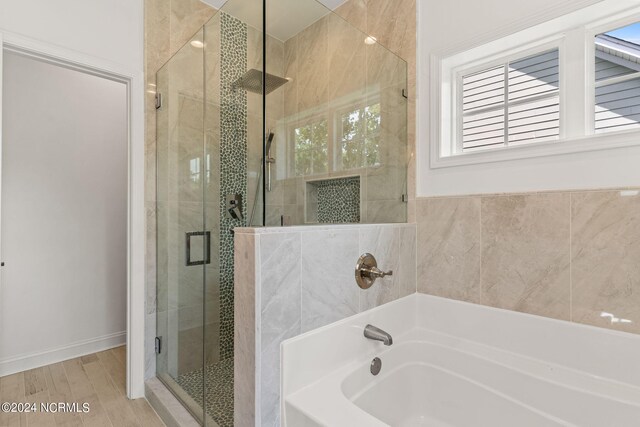 bathroom featuring walk in shower, vanity, and hardwood / wood-style flooring