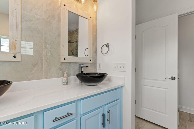 bathroom with plus walk in shower and wood-type flooring