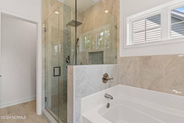 bathroom with shower with separate bathtub