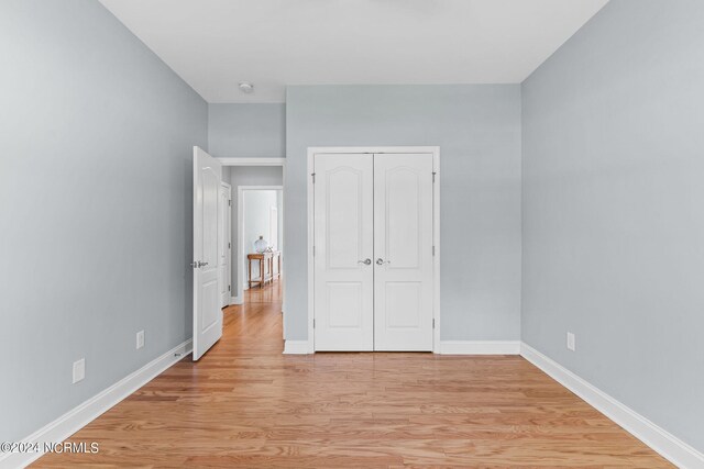 empty room with ceiling fan and light wood-type flooring