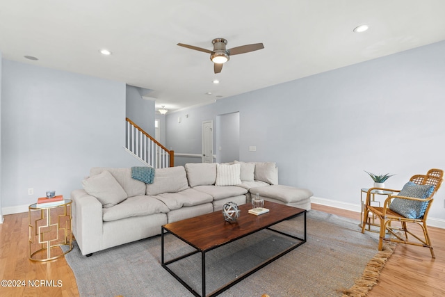 living room featuring ceiling fan and light hardwood / wood-style flooring