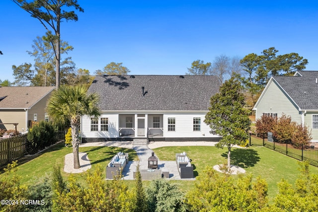 rear view of property featuring a yard, an outdoor hangout area, and a patio