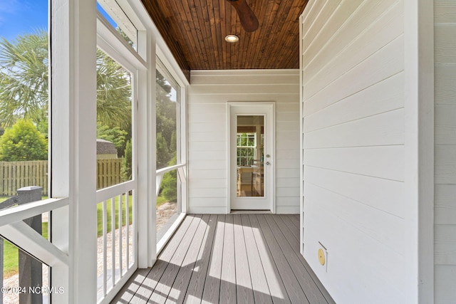 unfurnished sunroom with ceiling fan