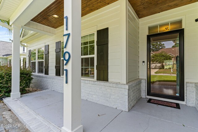 back of house with a sunroom, a yard, and a patio