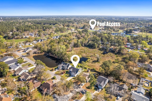 birds eye view of property featuring a forest view, a residential view, and a water view