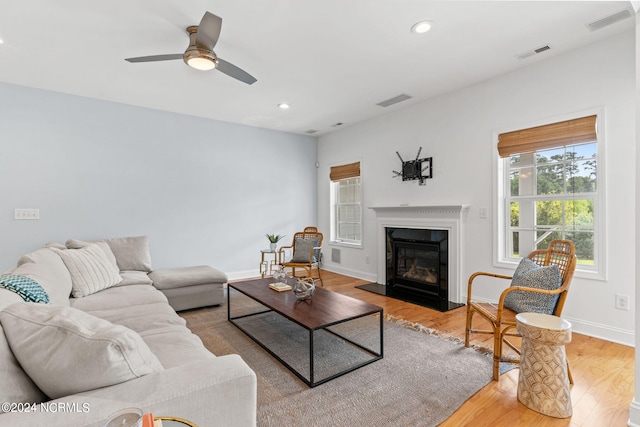 living room featuring ceiling fan and light hardwood / wood-style floors