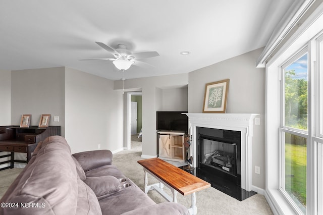 carpeted living room with ceiling fan