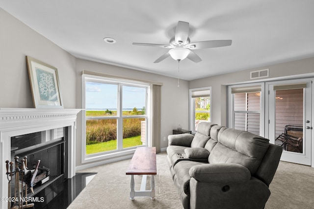 living room with ceiling fan, carpet, and a high end fireplace