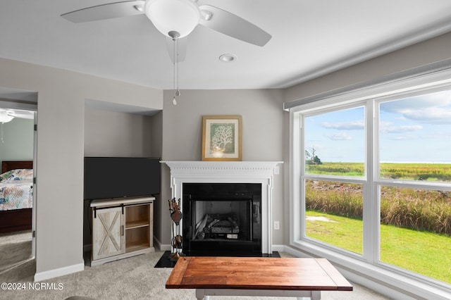 living room with light colored carpet and ceiling fan