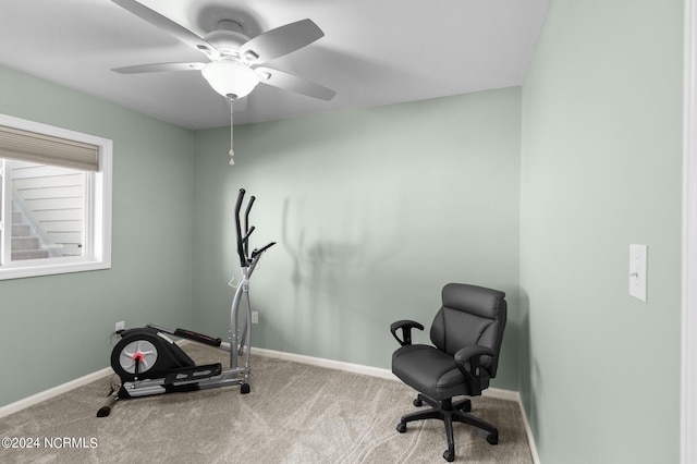 exercise room with light carpet and ceiling fan