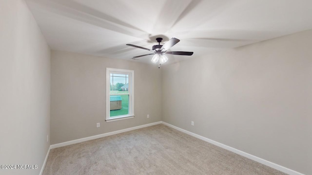 spare room featuring ceiling fan and light carpet