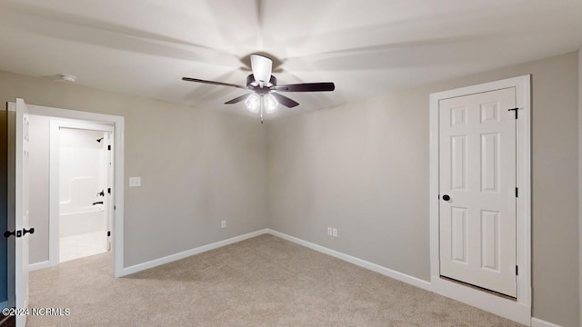 unfurnished room featuring light colored carpet and ceiling fan