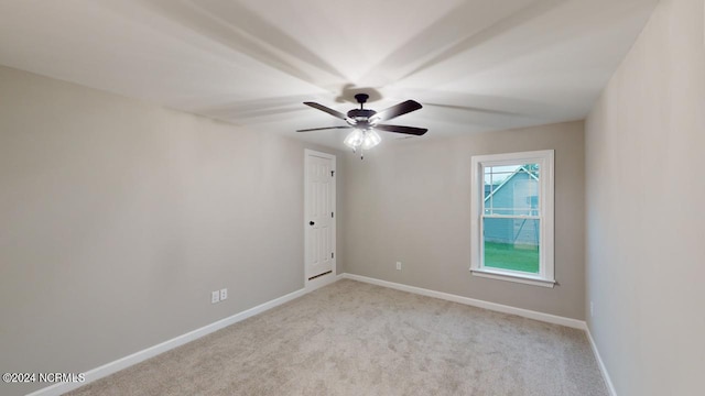 empty room with light carpet and ceiling fan