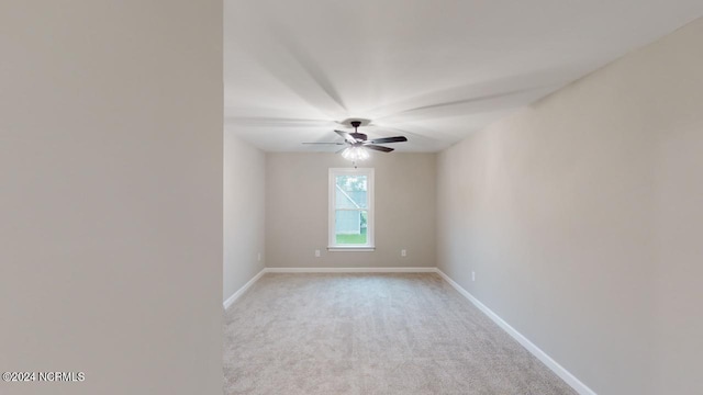 spare room featuring light carpet and ceiling fan