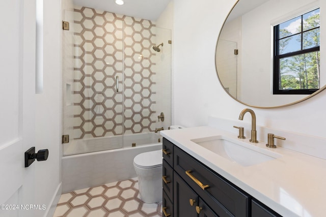 full bathroom featuring enclosed tub / shower combo, vanity, and toilet