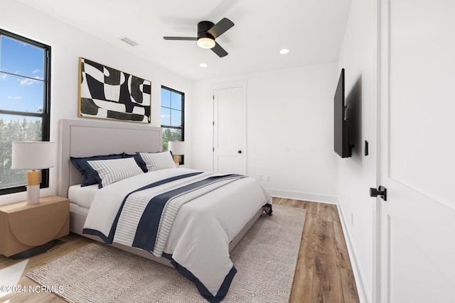 bedroom featuring ceiling fan and light hardwood / wood-style flooring