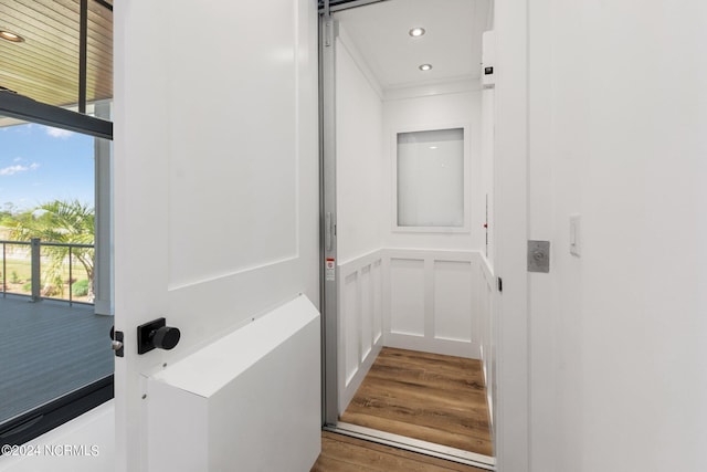 interior space with hardwood / wood-style floors and elevator