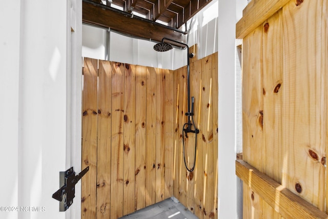 details featuring walk in shower and wood walls