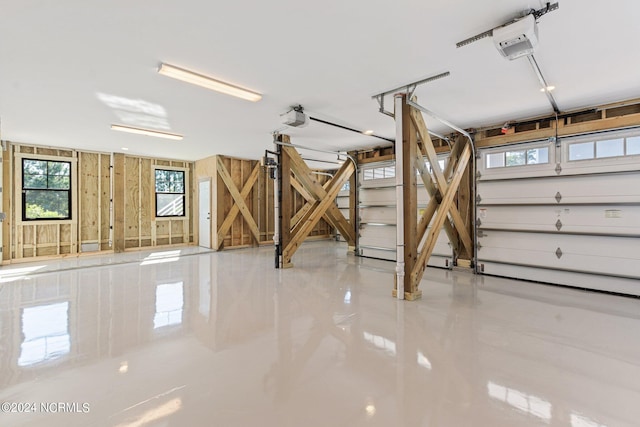 garage with a garage door opener and wooden walls