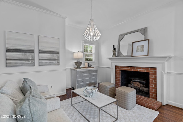 living room with an inviting chandelier, a fireplace, ornamental molding, and dark hardwood / wood-style floors