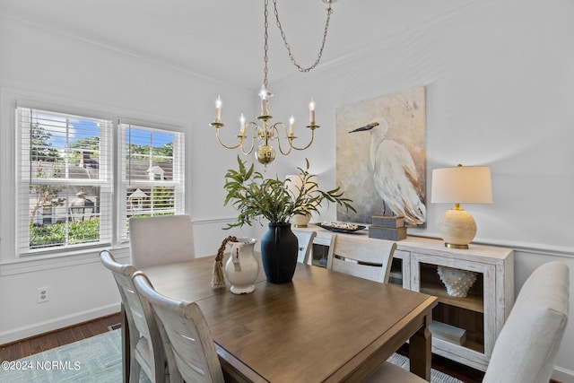 dining area featuring an inviting chandelier, crown molding, and dark hardwood / wood-style floors