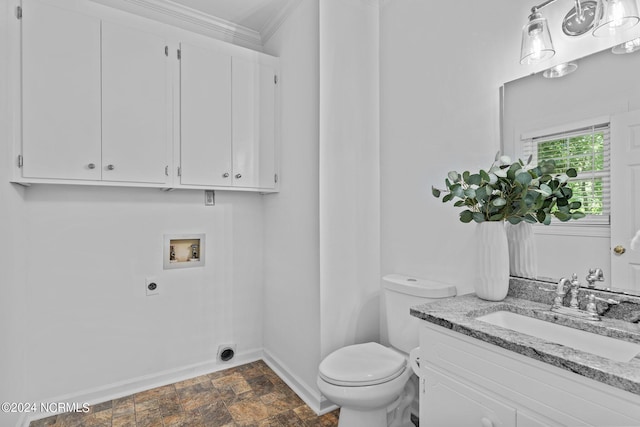 bathroom featuring vanity, crown molding, and toilet