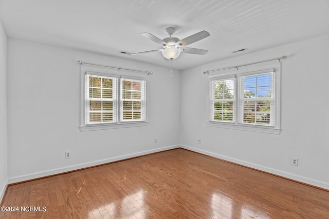 empty room with light hardwood / wood-style flooring and ceiling fan