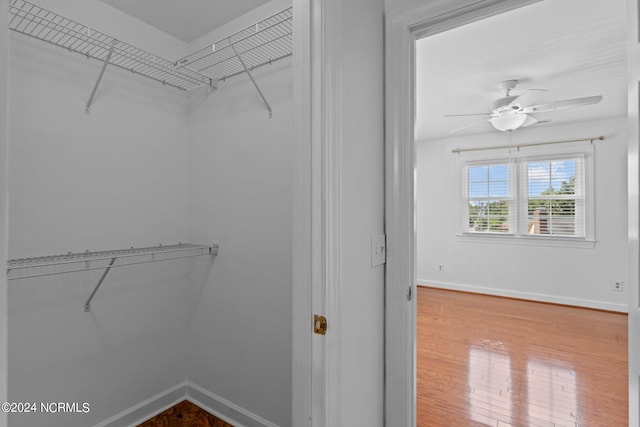 walk in closet with ceiling fan