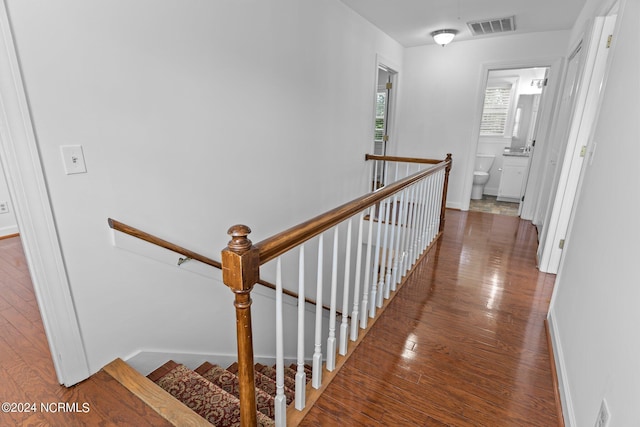 hall with hardwood / wood-style flooring