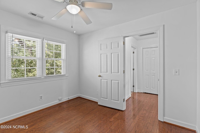 spare room featuring ceiling fan and dark hardwood / wood-style flooring