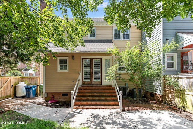 rear view of house featuring central AC