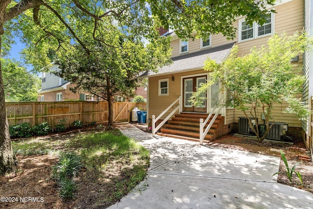 rear view of property with a patio and central air condition unit