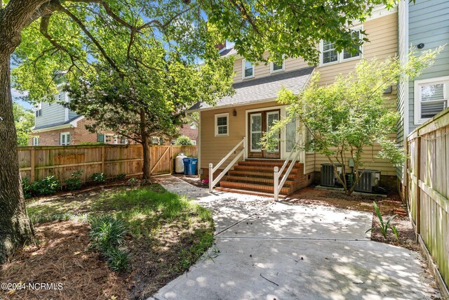 rear view of house featuring central air condition unit and a patio area