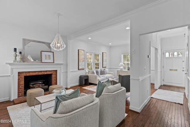 living room with crown molding, a fireplace, and dark hardwood / wood-style floors