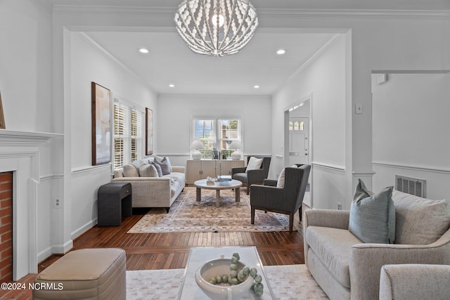 living room featuring a notable chandelier, hardwood / wood-style flooring, and ornamental molding