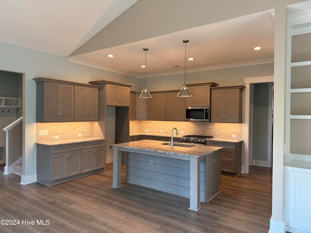 kitchen with light stone countertops, stainless steel appliances, dark hardwood / wood-style flooring, backsplash, and decorative light fixtures