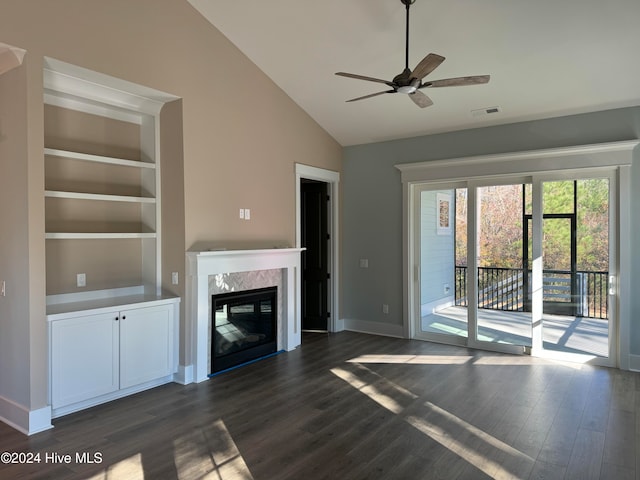 unfurnished living room featuring a premium fireplace, ceiling fan, dark wood-type flooring, and high vaulted ceiling