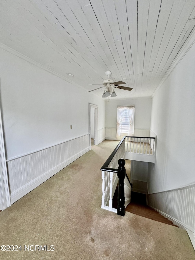 interior space featuring ornamental molding, carpet floors, and ceiling fan