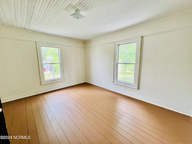 unfurnished room with a wealth of natural light and hardwood / wood-style floors