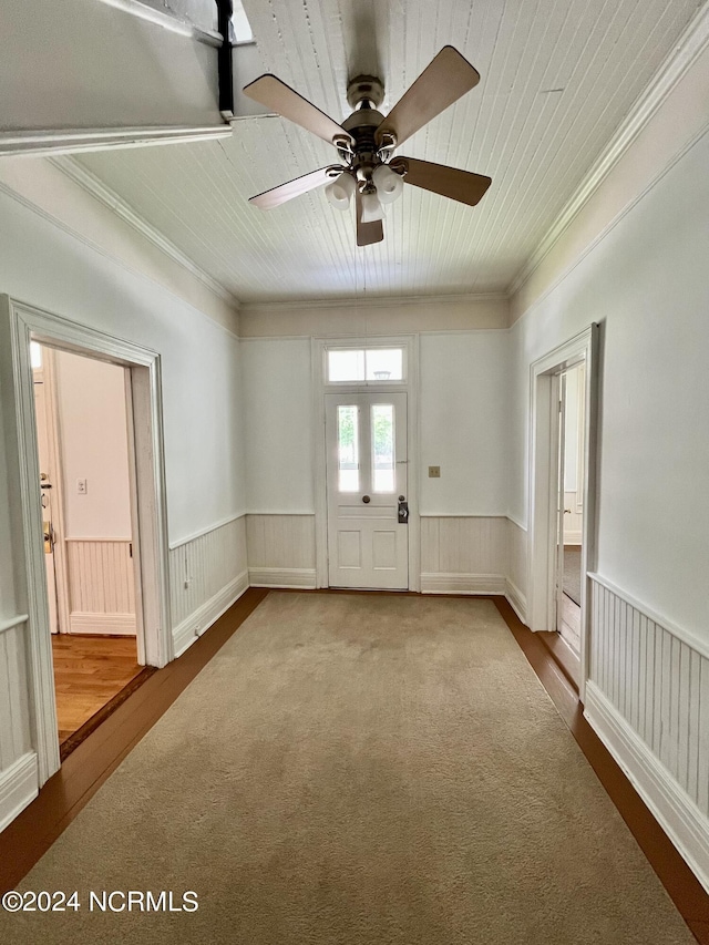 empty room with ceiling fan, crown molding, and hardwood / wood-style flooring