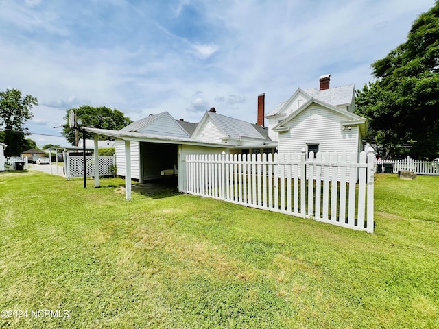 back of property with a lawn