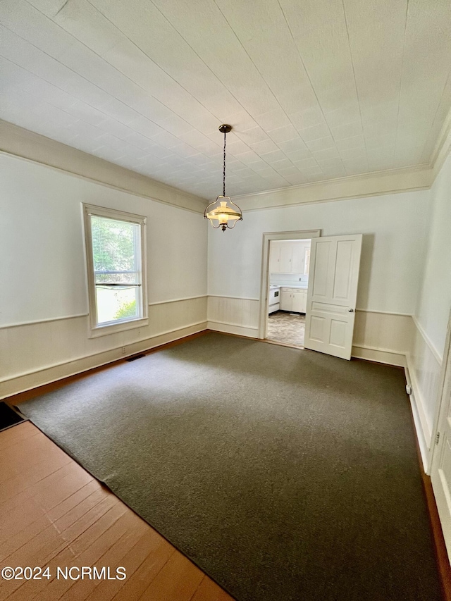 unfurnished living room with ornamental molding and wood-type flooring