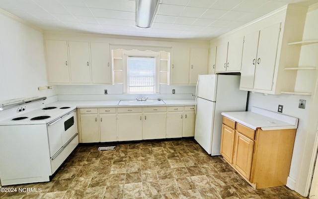 kitchen with white cabinetry, sink, white appliances, and light tile patterned floors