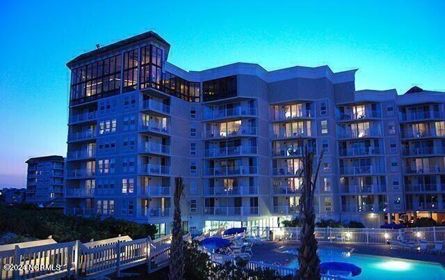 outdoor building at dusk featuring a community pool