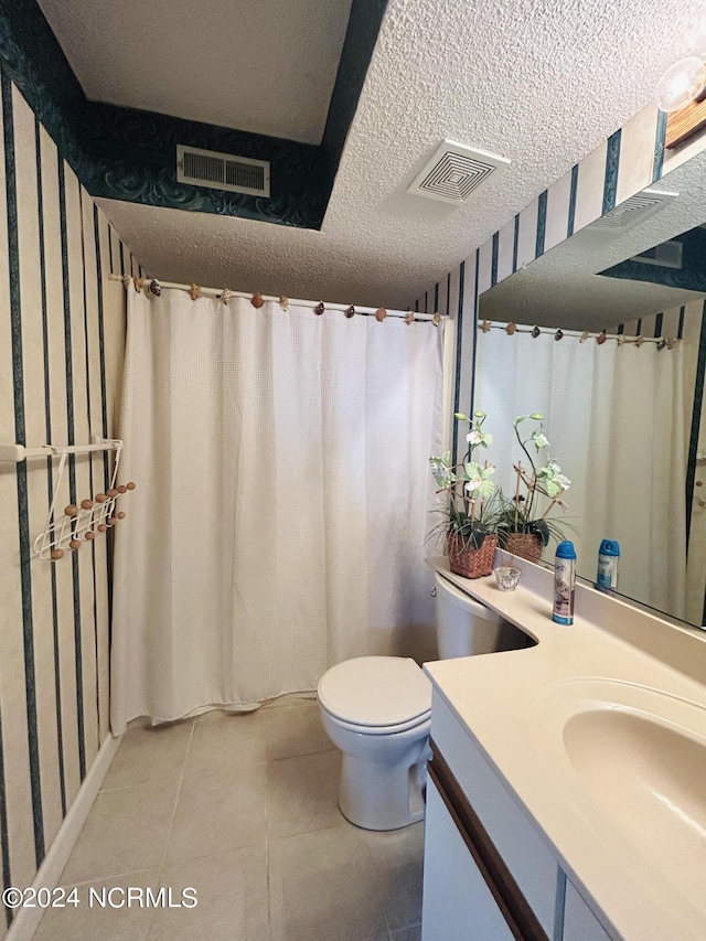 full bath featuring toilet, visible vents, a textured ceiling, and vanity