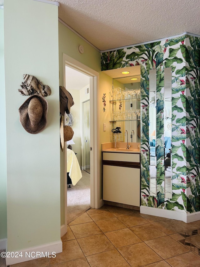 corridor featuring light tile patterned flooring and a textured ceiling